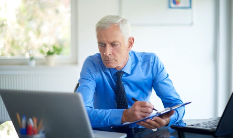 Landlord reviewing rental figures and tenancy documents on a laptop while planning a fair Section 13 rent increase for a family tenancy