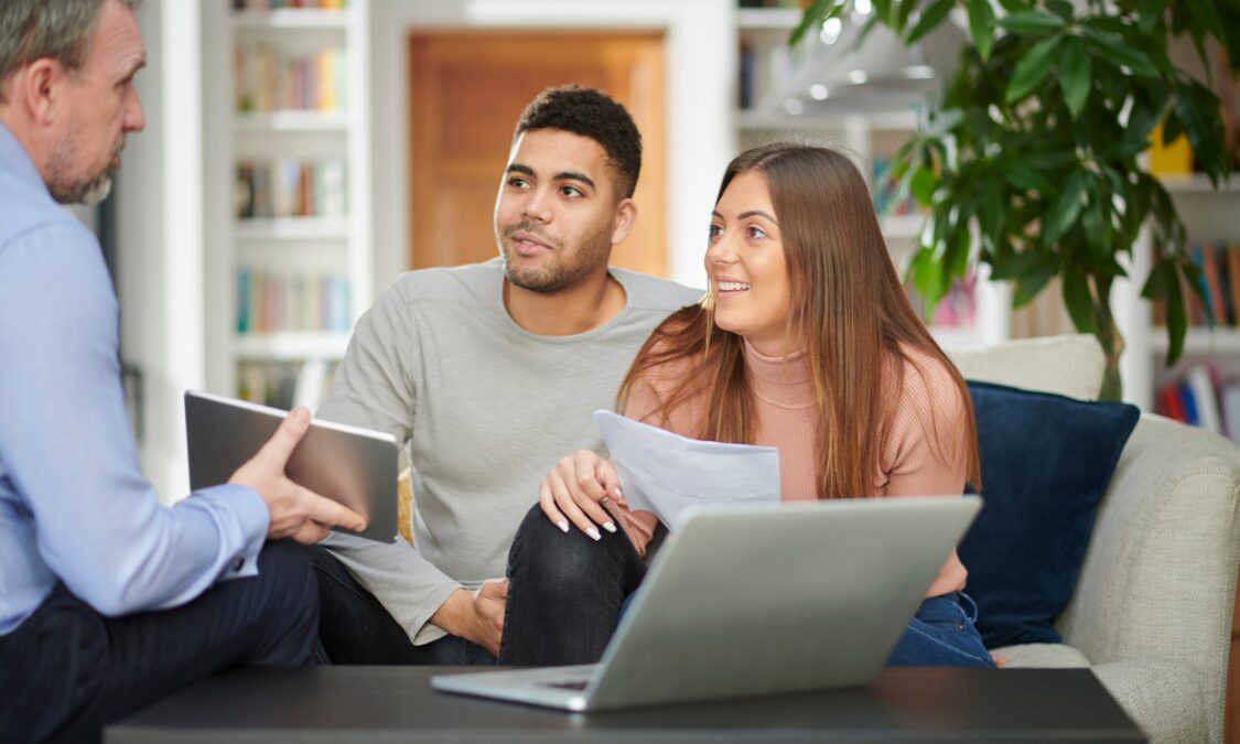 A couple meeting with an estate agent to discuss buying or renting a home in Heckington, Lincolnshire.